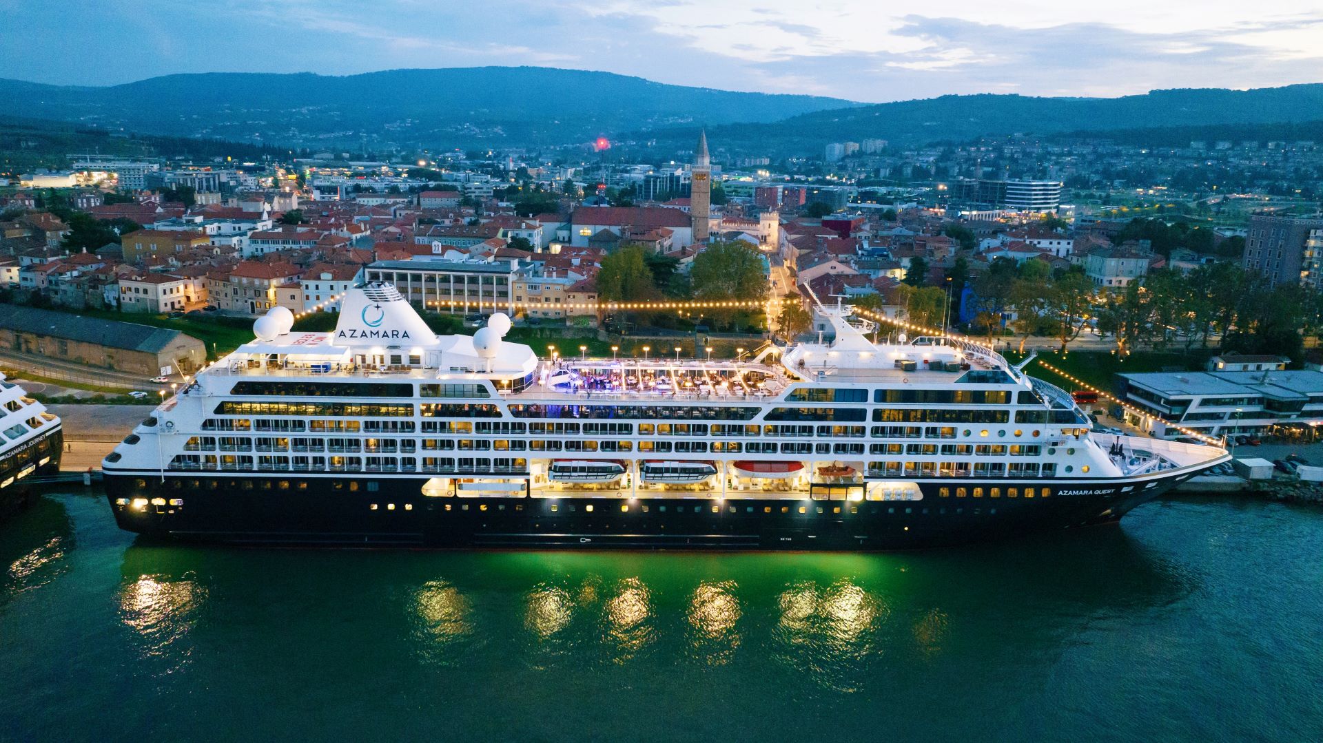 Azamara Quest illuminated beside Koper in the evening