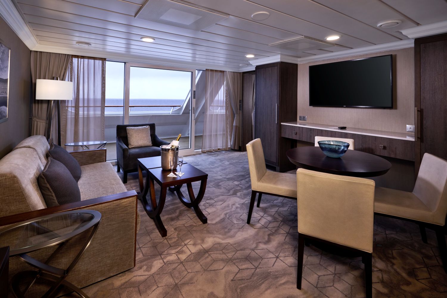 Azamara World Owner’s Suite living room with veranda doors and dining table