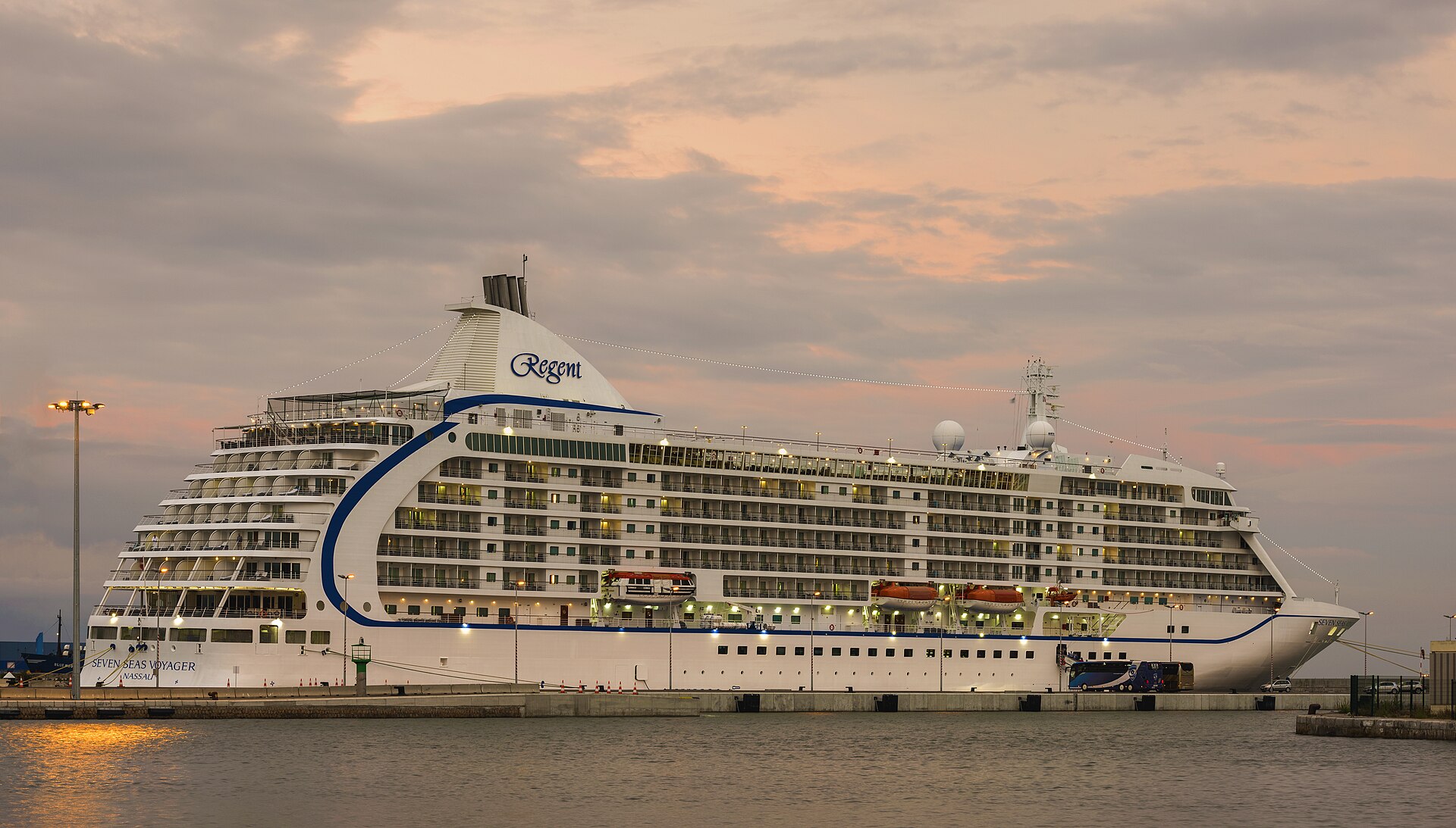 Seven Seas Voyager luxury cruise ship illuminated at dusk