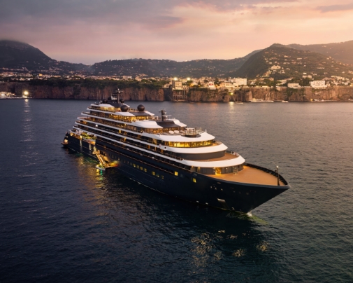 Ritz-Carlton Evrima luxury yacht sailing near a coastal island