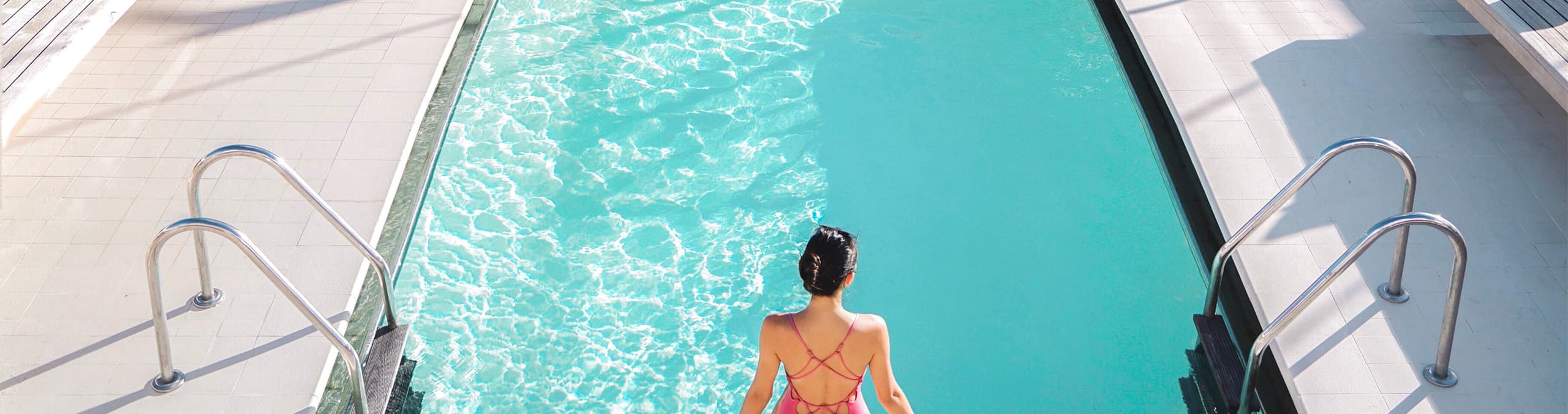 Guest enjoying the pool aboard a Seabourn luxury cruise ship