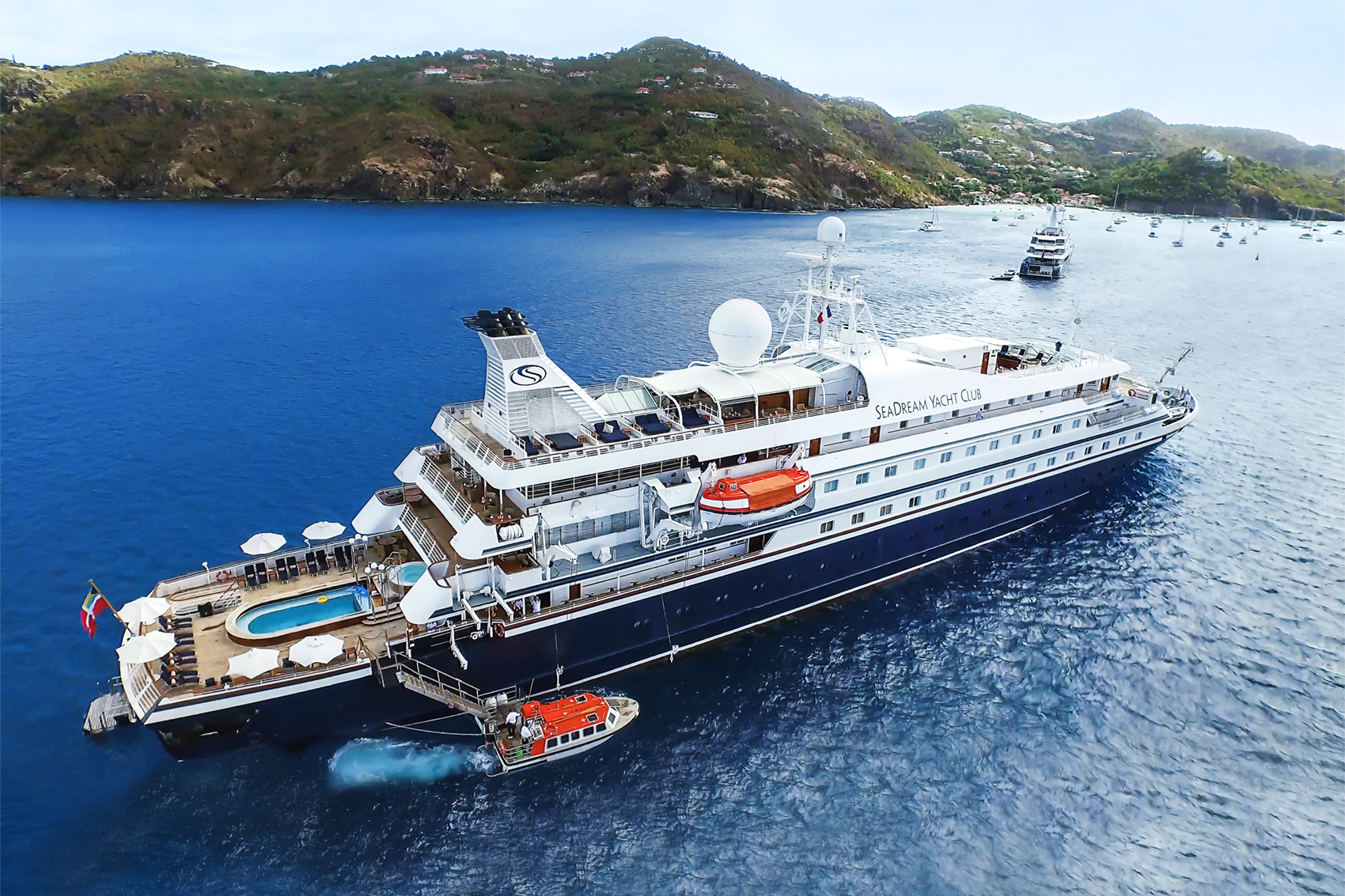 A SeaDream yacht at a green island anchorage.