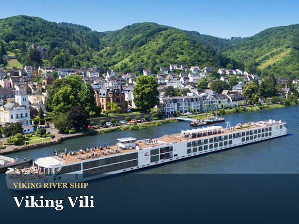 Viking Vili cruise ship — River cruise ship passing scenic European village
